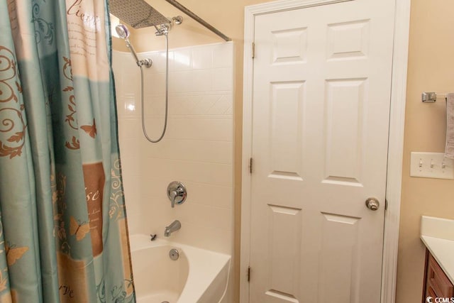 bathroom featuring shower / bath combo and vanity