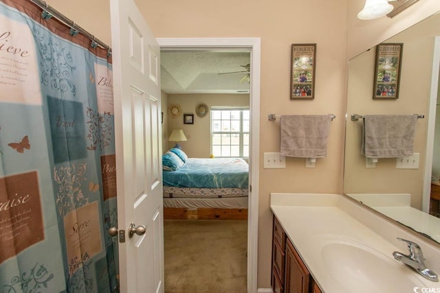 bathroom with a textured ceiling, walk in shower, and vanity