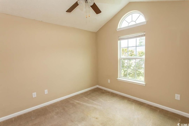 unfurnished room with vaulted ceiling, ceiling fan, and carpet floors