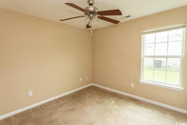 spare room featuring a healthy amount of sunlight, carpet flooring, and ceiling fan