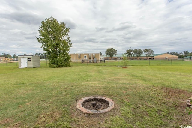 view of yard with a storage unit and a fire pit