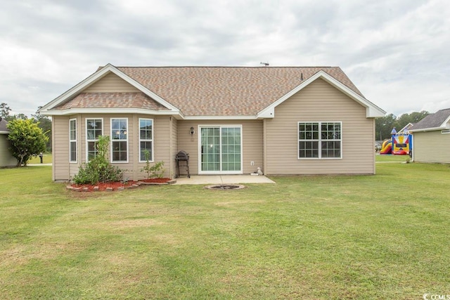 rear view of house with a lawn and a patio area