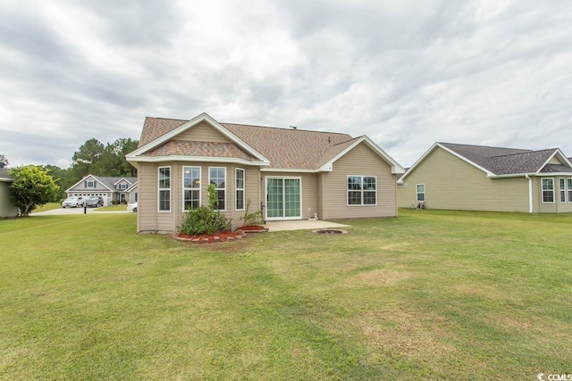 back of property with a patio area and a yard