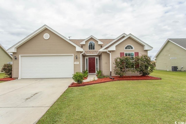 view of front of house with a front yard, a garage, and central AC