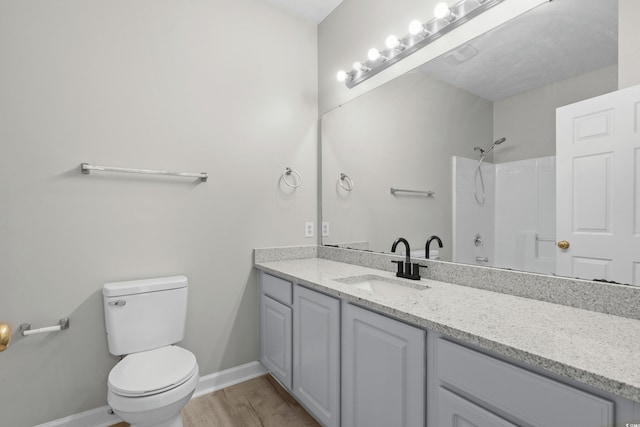 bathroom with walk in shower, vanity, toilet, and hardwood / wood-style flooring