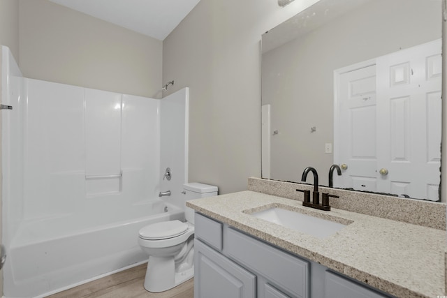 full bathroom featuring shower / bathing tub combination, vanity, toilet, and hardwood / wood-style flooring