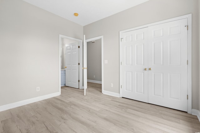 unfurnished bedroom featuring light hardwood / wood-style flooring and a closet