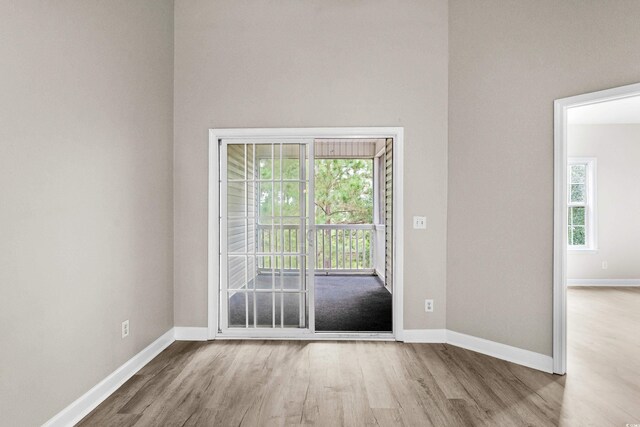 unfurnished room with light hardwood / wood-style floors and a wealth of natural light