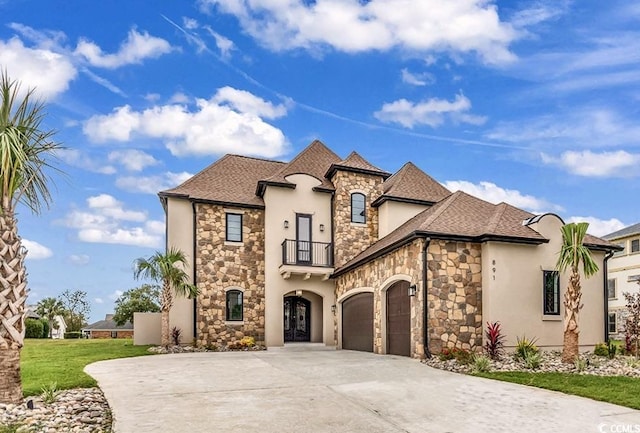 french provincial home with a balcony, an attached garage, stone siding, and concrete driveway