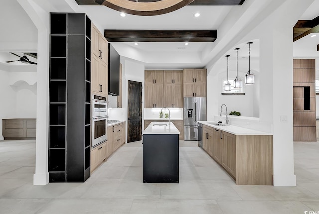 kitchen with stainless steel appliances, beam ceiling, a center island, decorative light fixtures, and sink