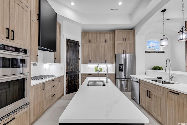 kitchen with pendant lighting, a large island, stainless steel appliances, and sink