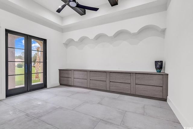 empty room featuring ceiling fan and french doors