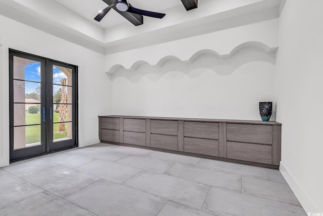 empty room with baseboards, french doors, and a ceiling fan
