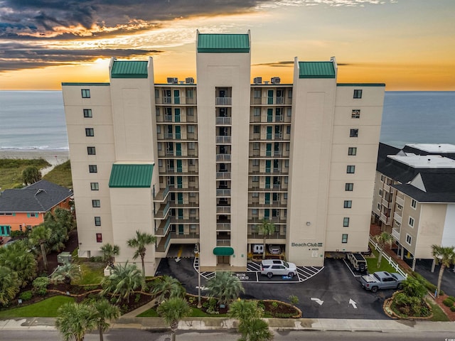 outdoor building at dusk featuring a water view