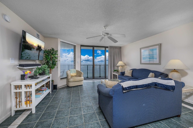 living room with expansive windows, a textured ceiling, and ceiling fan