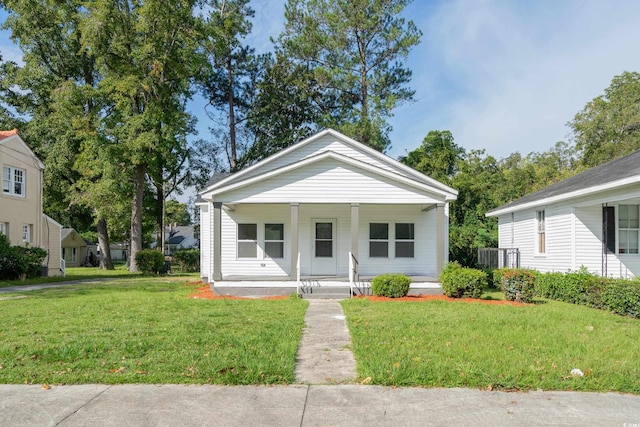 bungalow with a porch and a front yard