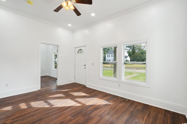 unfurnished room with crown molding, a high ceiling, dark hardwood / wood-style flooring, and ceiling fan