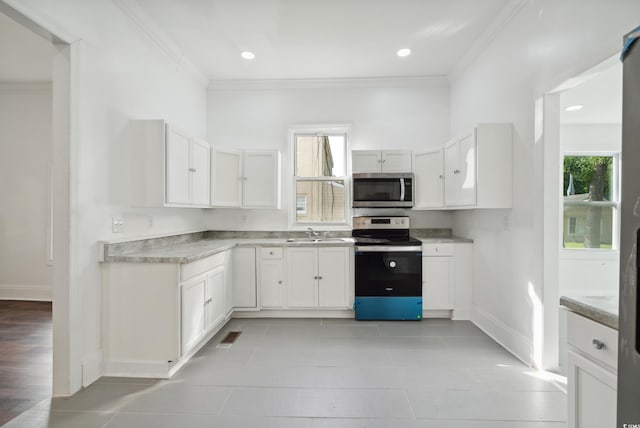 kitchen featuring light hardwood / wood-style flooring, white cabinets, appliances with stainless steel finishes, and sink