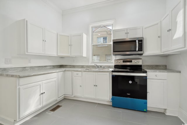 kitchen with light tile patterned floors, ornamental molding, sink, white cabinetry, and stainless steel appliances