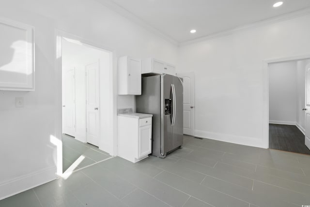 kitchen featuring ornamental molding, white cabinetry, stainless steel fridge with ice dispenser, and tile patterned floors