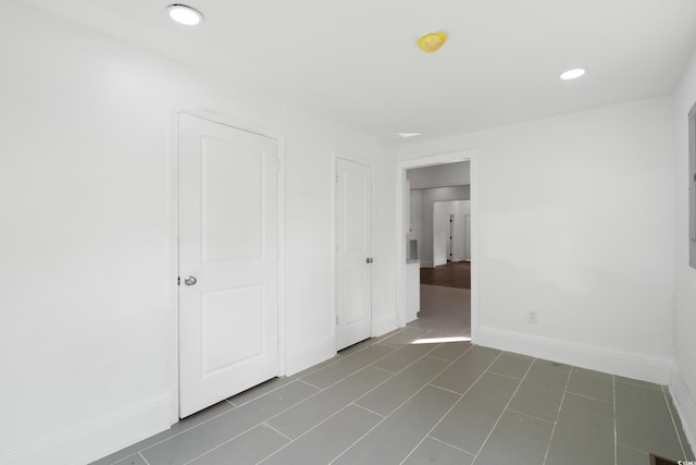 unfurnished bedroom featuring dark tile patterned flooring