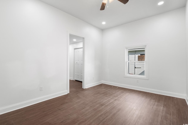 unfurnished room with dark hardwood / wood-style flooring and ceiling fan