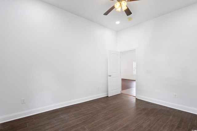 spare room with ceiling fan and dark hardwood / wood-style floors