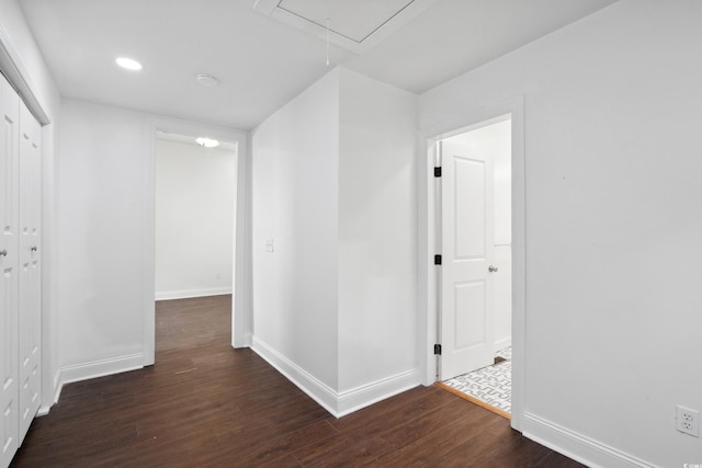 corridor with dark hardwood / wood-style flooring