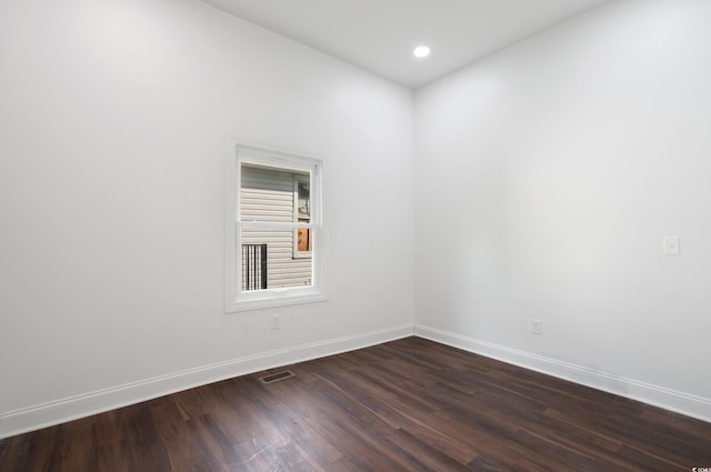 unfurnished room featuring dark hardwood / wood-style flooring