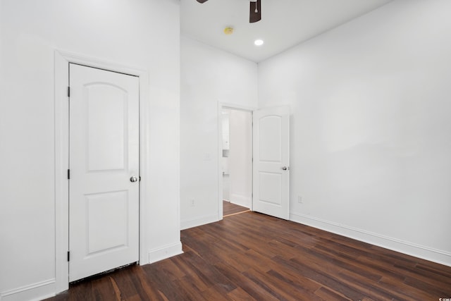 unfurnished bedroom with ceiling fan and dark hardwood / wood-style floors