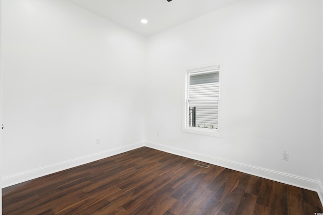 spare room featuring dark wood-type flooring