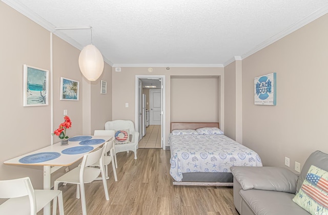 6900 N Ocean Blvd Unit 1040, Myrtle Beach, SC 29572 - bedroom with light wood finished floors, a textured ceiling, and crown molding