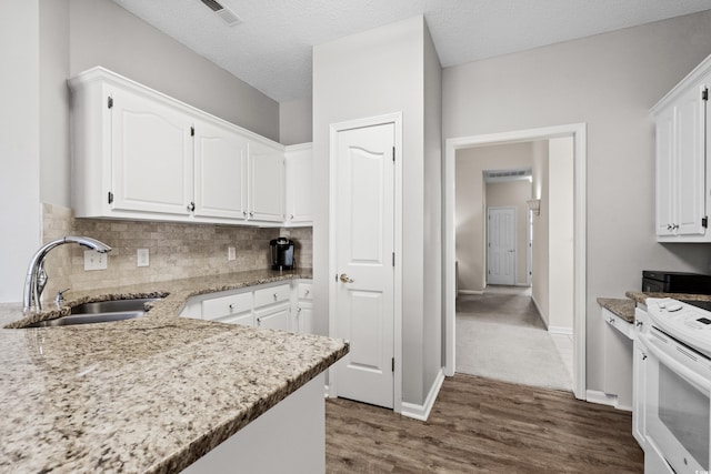 kitchen with a textured ceiling, dark hardwood / wood-style floors, sink, white cabinetry, and white range oven