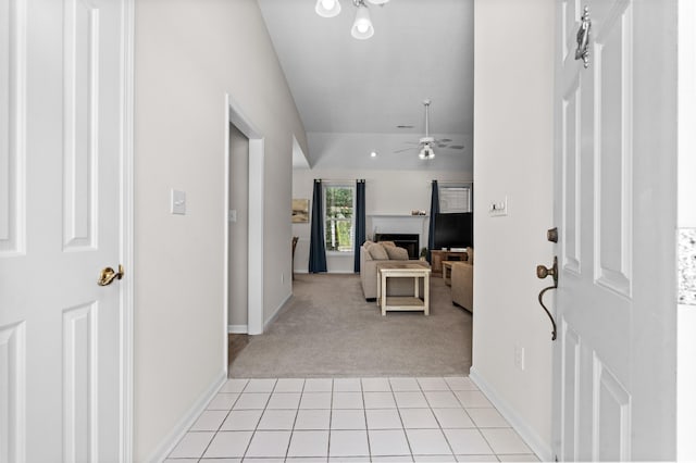 carpeted entryway with ceiling fan