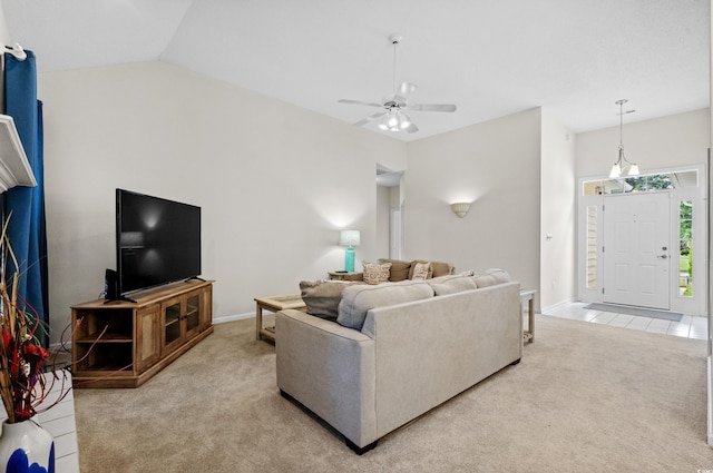 living room featuring vaulted ceiling, ceiling fan, and light colored carpet