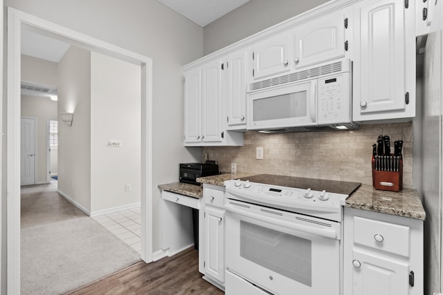 kitchen featuring wood-type flooring, light stone counters, white appliances, and white cabinetry