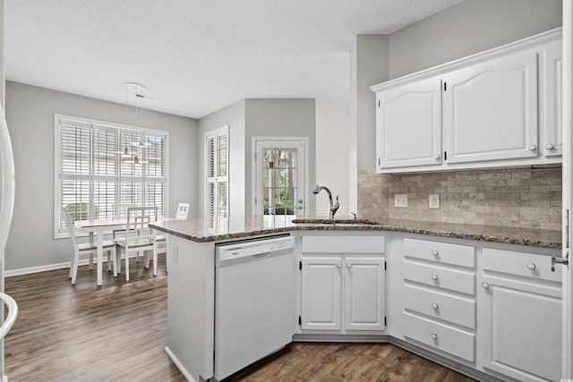 kitchen featuring white dishwasher, dark hardwood / wood-style floors, white cabinetry, and sink