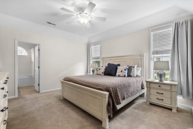 carpeted bedroom featuring ceiling fan, a textured ceiling, and connected bathroom