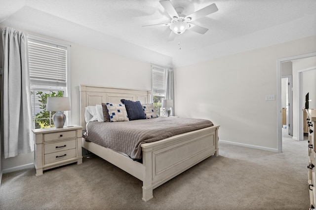 carpeted bedroom featuring a textured ceiling and ceiling fan