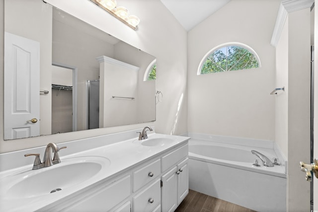 bathroom with separate shower and tub, vaulted ceiling, hardwood / wood-style floors, and vanity