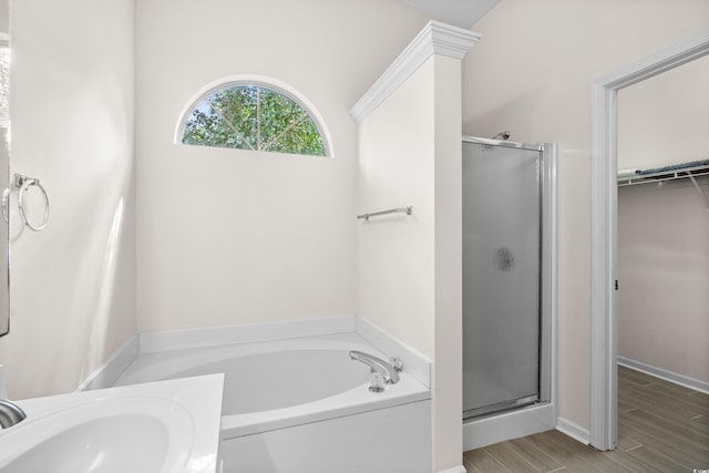 bathroom featuring hardwood / wood-style floors and separate shower and tub