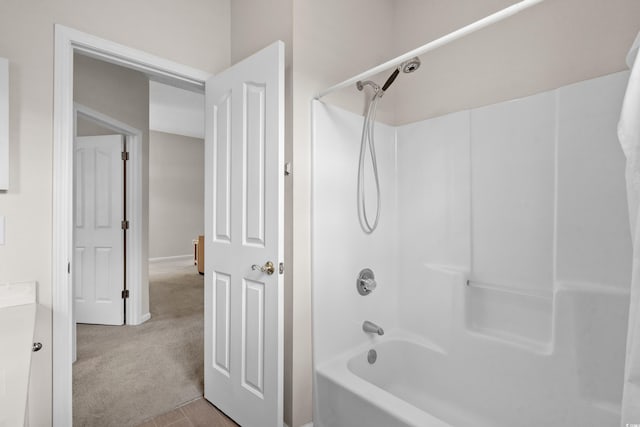 bathroom featuring washtub / shower combination and vanity