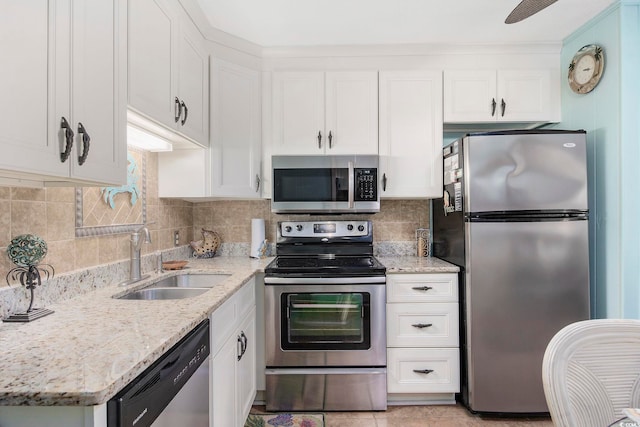 kitchen featuring appliances with stainless steel finishes, sink, and white cabinets