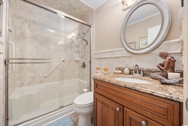 bathroom featuring toilet, walk in shower, vanity, and tile walls