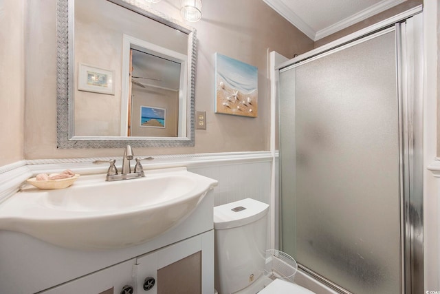 bathroom featuring vanity, toilet, walk in shower, and ornamental molding