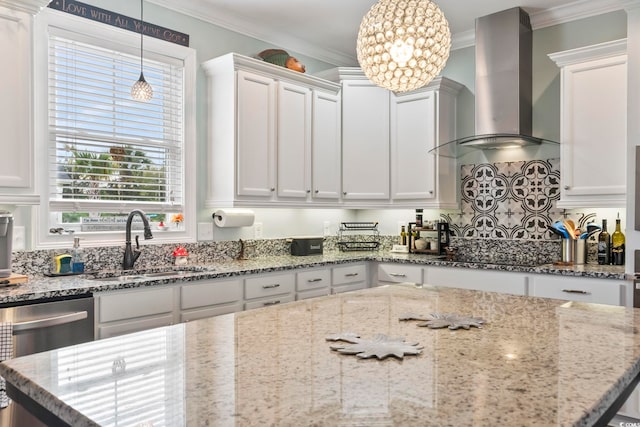 kitchen featuring pendant lighting, wall chimney range hood, sink, black electric stovetop, and white cabinets