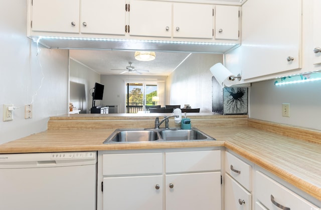 kitchen with white cabinets, white dishwasher, a textured ceiling, and sink