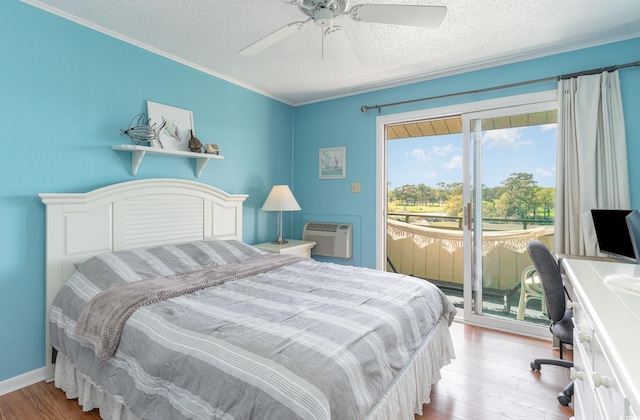 bedroom with access to exterior, light wood-type flooring, a textured ceiling, ceiling fan, and a wall mounted air conditioner