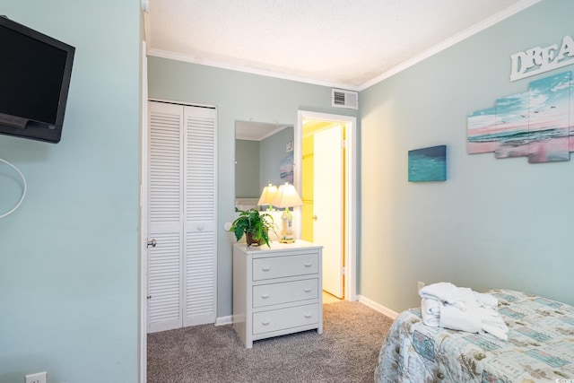 carpeted bedroom featuring ornamental molding, a closet, and a textured ceiling