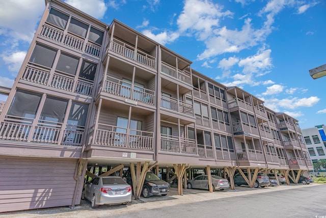 207 N Ocean Blvd Unit 241, North Myrtle Beach, SC 29582 - view of apartment building / complex featuring covered parking